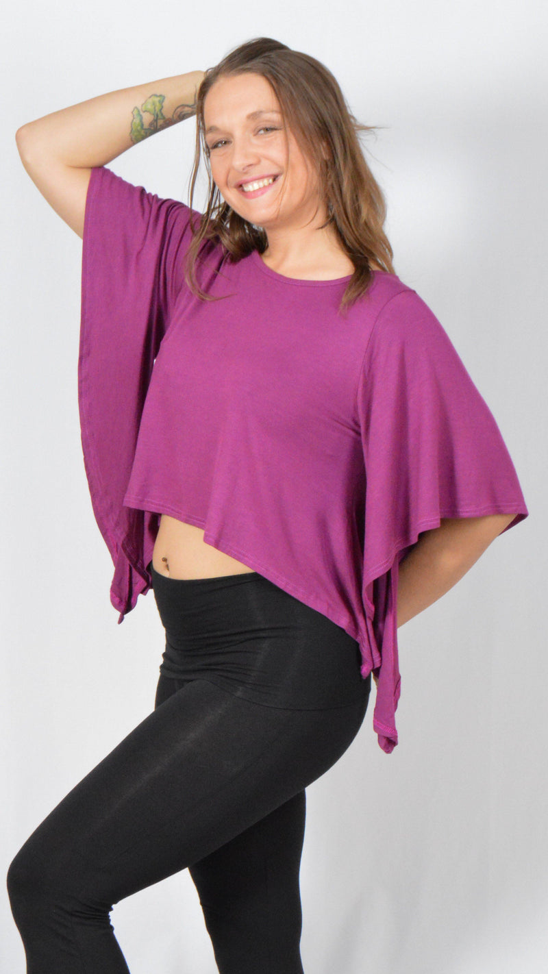 Girl wearing Umba's magenta Butterfly Sleeve Top with black leggings, front side view, festival fun, sold at Umba Love in Boulder, CO